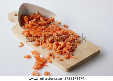 Dried shrimp in wooden tray on white background

