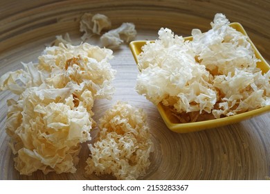Dried snow fungus (Tremella fuciformis) in bowl on bamboo tray. Asian cuisine mushroom.