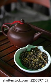 Dried tea leaves with clay teapot - Shutterstock ID 2253397435