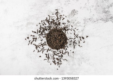 Dried Tea Is Poured Into A White Ceramic Cup On A Marble Table. View From Above. Layout.