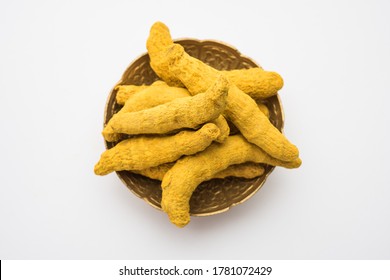 Dried Turmeric Roots or sookhi Haldi as a whole on white background, selective focus