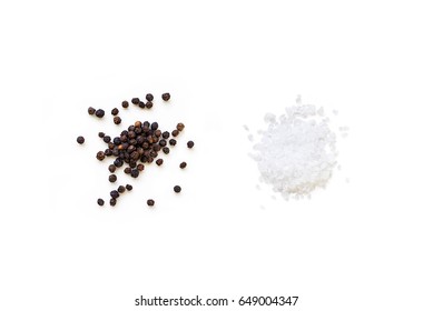 Dried whole seed of black pepper and white coarse sea salt isolated on a white background seen from above - Shutterstock ID 649004347