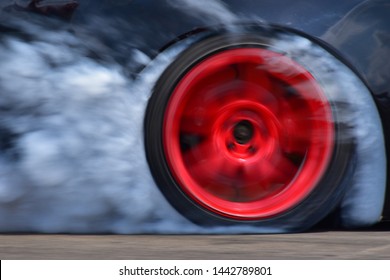 Drift Car Motion Spin Rotating Tire Wheel With White Smoke On The Road.