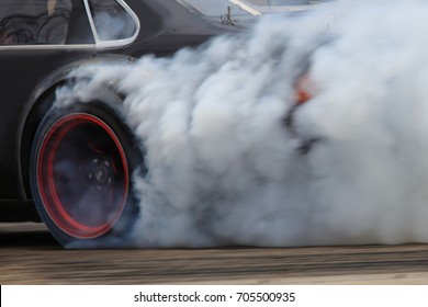 Drift Car Motion Spin Rotating Tire Wheel With White Smoke On The Road.