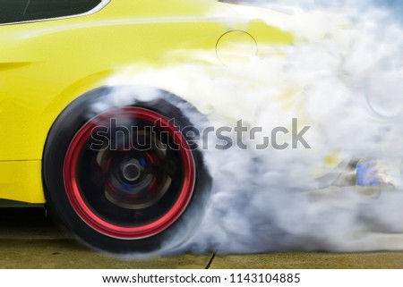 drift car motion spin rotating tire wheel with white smoke on the road.
