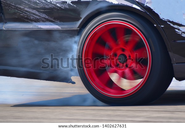 drift car motion spin rotating tire wheel with
white smoke on the road.