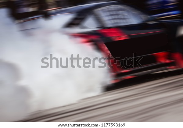 Drift car on Track.Professional drift car a\
lot of Smoke. Motion Blur Drift\
car.