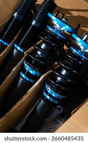 Drift Coilover Suspension Set in Box. High-performance coilovers for drift build ready for installation. New drift coilover suspension kit in box before chassis install