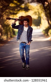 Drifter, Man With Guitar Walking Outdoors