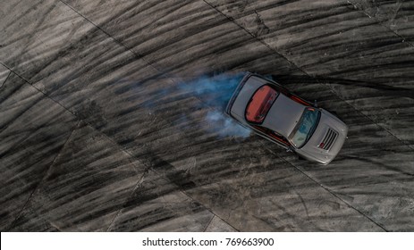 Drifting car, Aerial view drifting car on race track, Abstract texture and background black tire tracks skid on asphalt road, Wheel tire tracks background, Car tire track skid mark on race track.
