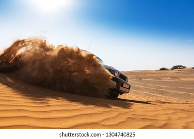 Drifting offroad car 4x4 in desert. Freeze motion of exploding sand powder into the air. Action and leasure activity. - Shutterstock ID 1304740825