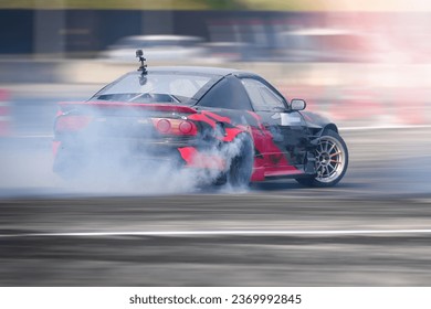 Drifting Sports sedan with modified engine and suspension action car slide faster on asphalt track speed motion blurred  with wheel tire  turning slip burn rubber smoke, Drift motor sport car racing .