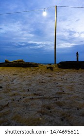 Driftwood Log On Sea Coast. Feel Loney With Two Lamp