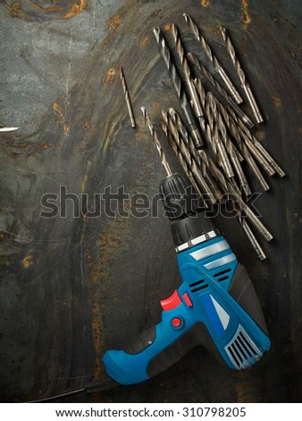 Dril and set of bit drils on steel plate texture