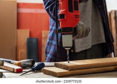 Drill Electric Tool, Hand Drilling Wood. Construction Industry, Carpenter Work Bench Table Closeup View