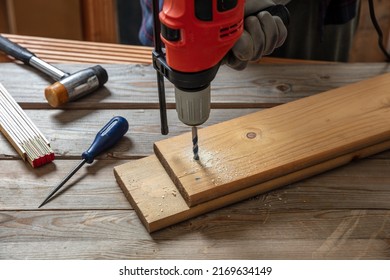 Drill Electric Tool, Hand Drilling Wood. Construction Industry, Carpenter Work Bench Table Closeup View