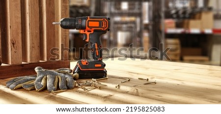 Drill on desk and workshop interior. 