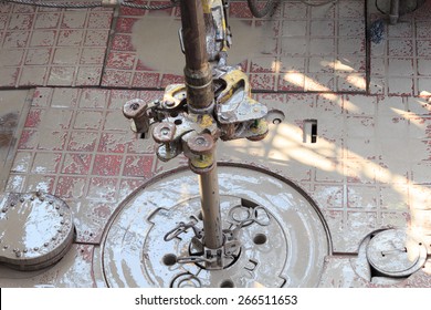 Drill Pipe And Rig Tong On The Rig Floor While Making Up For Drilling With Dirty Water Based Mud