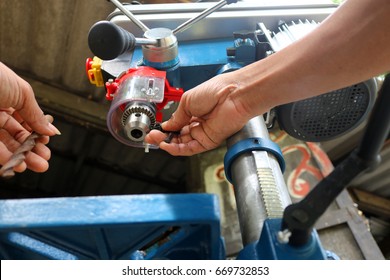 Drill presses machine with machinist. - Powered by Shutterstock