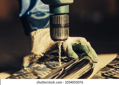 Drill screwdriver workflow creation of metal parts. male metal worker using drillpress. Toned image. from the side view - Powered by Shutterstock