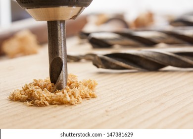 Drilled Hole With Saw Dust On Wood Table