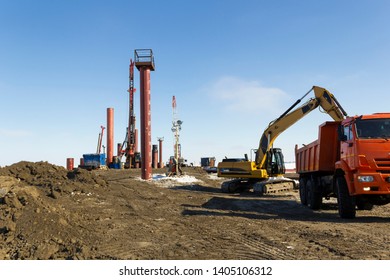 Drilling Equipment, Excavators, Trucks Build The Sea Port Of Sabetta. Yamal, Russia. Winter, Sunny