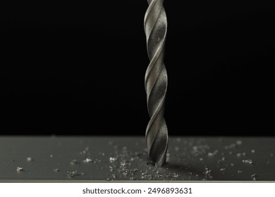 Drilling hole in grey surface on black background, closeup - Powered by Shutterstock