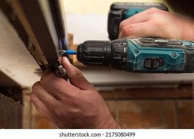 Drilling And Installation Of Interior Doors, The Craftsman Makes A Hole In The Door Frame With A Hand Drill, Doors And Installation.