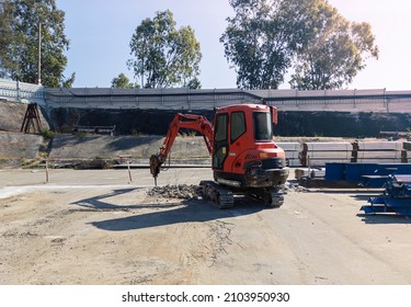 Drilling Into Concrete Road Pavement With Hydraulic Hammer Breaker For Backhoe For Repair Damaged Roads