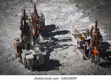 Drilling machine makes bore holes for explosives in open cast mine. Lithium Mine in Western Australia. Spodumene ore from the open cast mine.