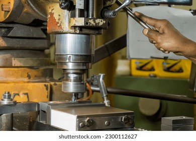 The drilling process on NC milling machine by skill operator. The metal working concept on the milling machine. - Powered by Shutterstock