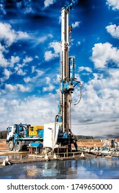 Drilling rig against a bare cloudy sky. Deep drilling. Industry, geology. Mineral exploration.