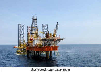 Drilling rig is installed side by side to production oil platform in offshore oil and gas field. - Shutterstock ID 1213466788