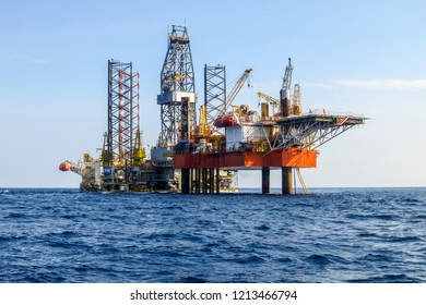 Drilling rig is installed side by side to production oil platform in offshore oil and gas field. - Shutterstock ID 1213466794