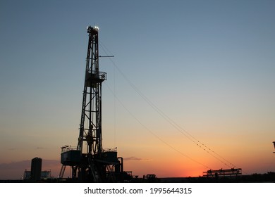 Drilling rig in the Permian Basin with a classic sunrise view of the West Texas Desert in the background.