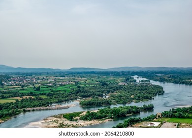 Drin River Valley Near Rozafa Castle (Shkoder, Albania) - Aerial View. Plain With A Stream Of Water Among Fields And Forests And A Village On The Shore