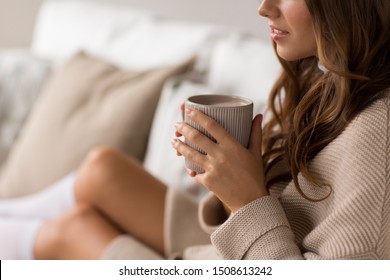 drink, christmas and hygge concept - close up of happy woman with cup of coffee in bed at home