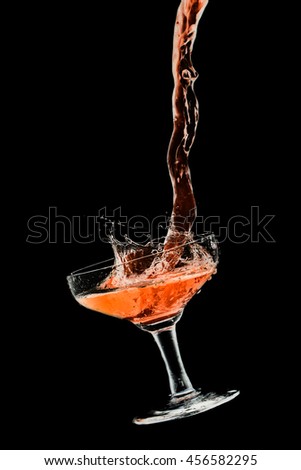 Drink cocktail glass splash out on a black background.