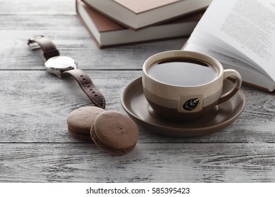 Drink coffee while reading book on table