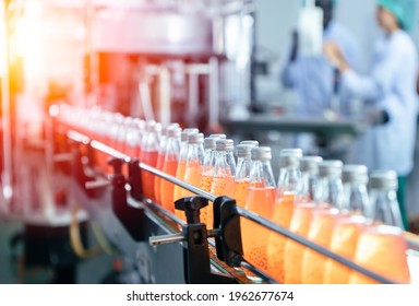 Drink factory production line fruit juice beverage product at conveyor belt. - Shutterstock ID 1962677674