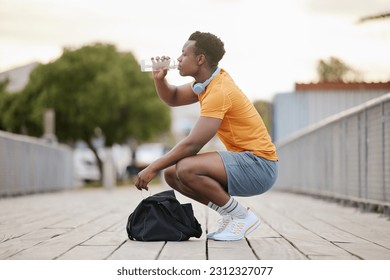 Drink, fitness and black man with water bottle in exercise, training or outdoor cardio workout. Athlete, drinking and healthy hydration or person relax after running in summer sport practice - Powered by Shutterstock