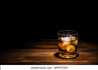 drink with ice on a wooden table