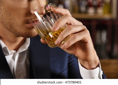 A Drink For The Man. Cropped Closeup Of A Man Drinking Whiskey At The Bar 