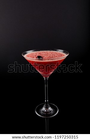 Drink in Martini Glass, Red Slush Ice summer drink with cherry on top, isolated on black background