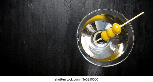 Drink Martini. Martini With Olives On A Black Table. Free Space For Text. Top View