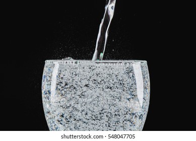 Drink : Pouring Pure Soda Into A Glass On Black Background