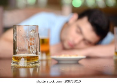 Drink responsibly. Portrait of drunk men sitting at the pub with his eyes closed