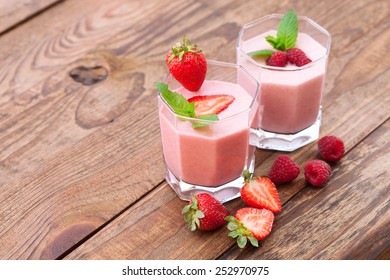 Drink smoothies summer strawberry, blackberry, raspberry on wooden table. Top view horizontal, Selective focus. - Powered by Shutterstock