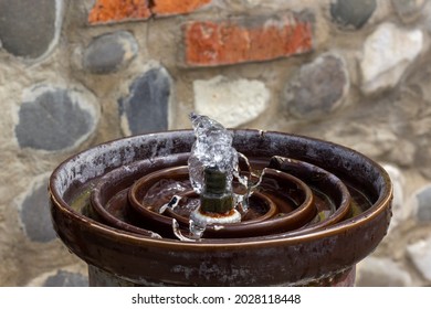 Drink Water Fountain Outdoor In A Park. Water Streaming From Metallic Drinking Fountain. Old Beautiful Stone Wall On Background. Nobody. No People. Concept Image.