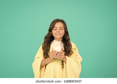 Drink Well, Live Well. Little Girl Drink Cocoa Or Milk Before Sleeping. Cosy And Fluffy Pajama. Feeling Comfortable At Home. Happy Girl With Tea Cup. Good Morning Drink. Small Kid Blue Background.